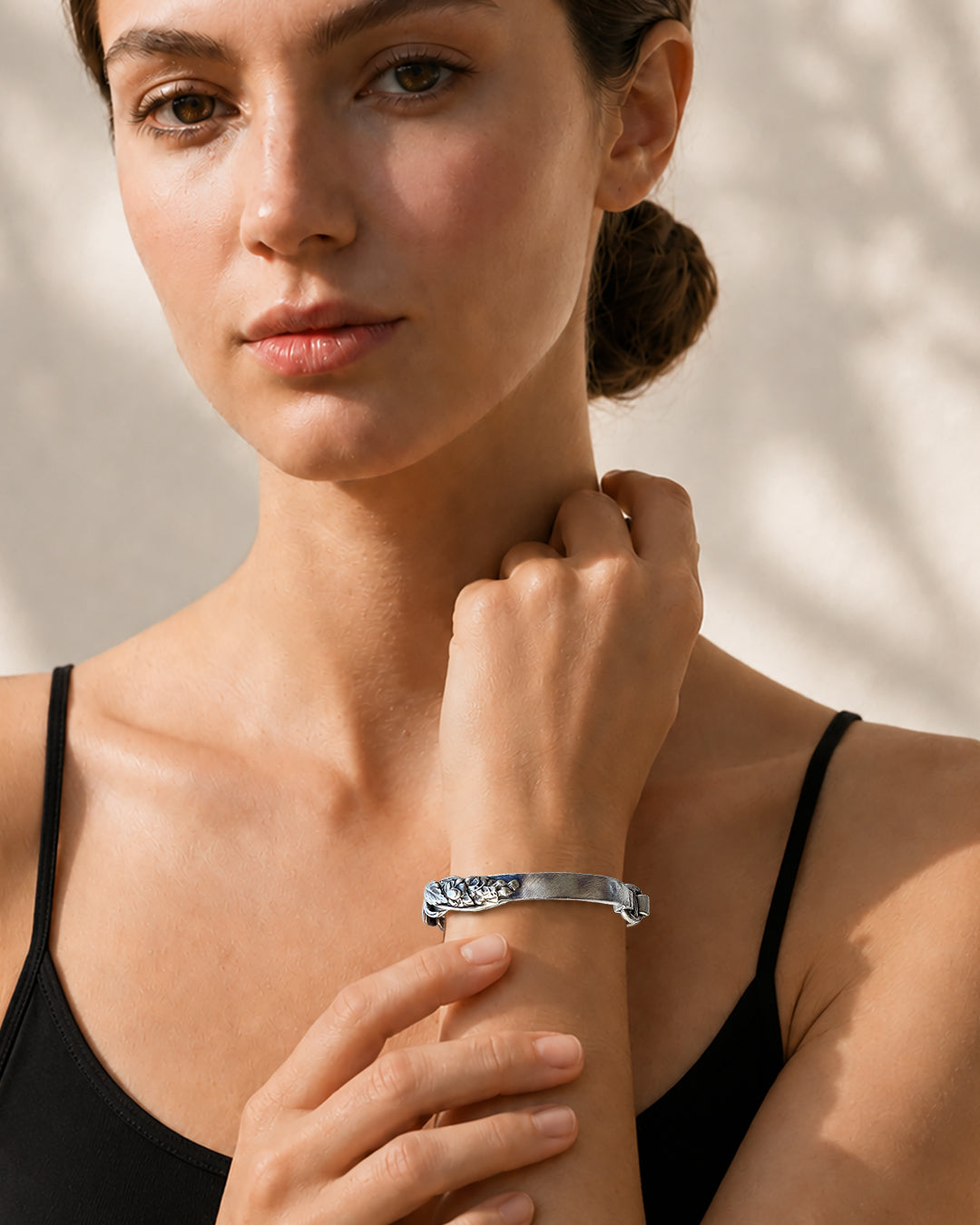 Woman wearing sterling silver Twisting Vine bracelet in blackened and brushed finish