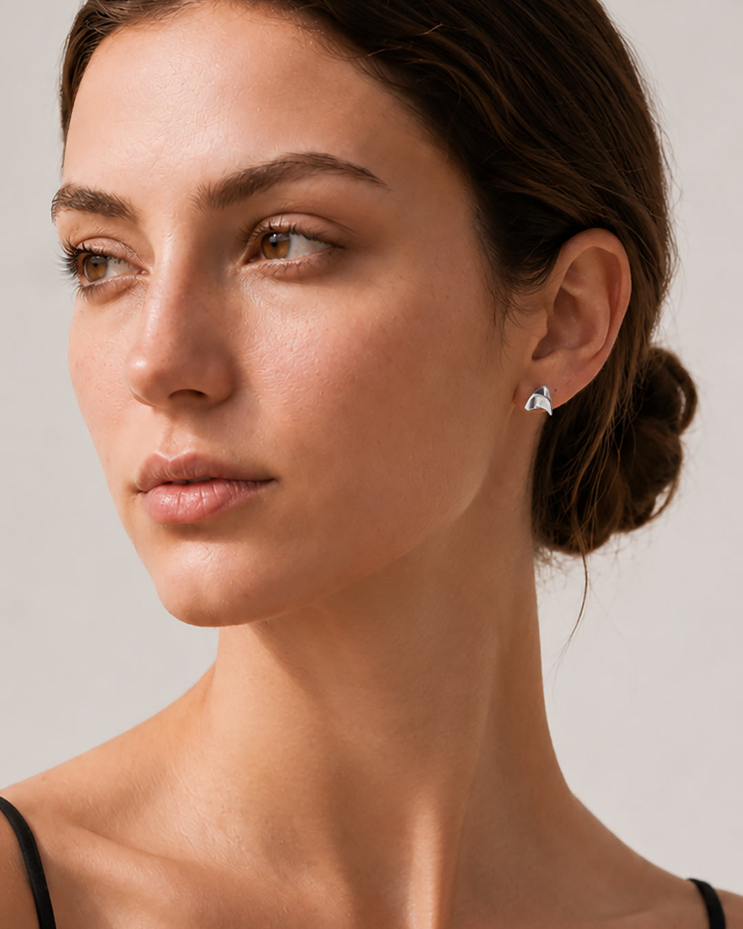 Woman wearing sterling silver Thorn Stud Earring in shiny finish