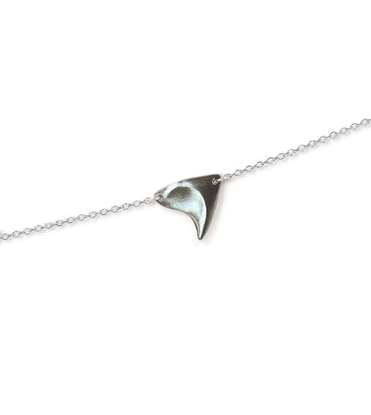 Closeup of a sterling silver rose thorn necklace in a brushed  finish on a white background