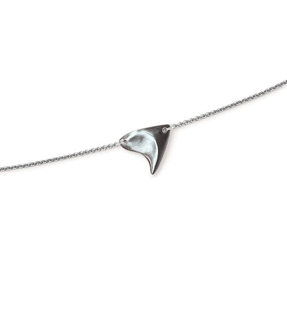 Closeup of sterling silver rose thorn in brushed matte finish