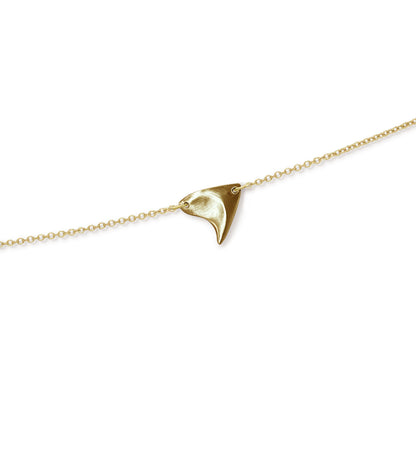 Closeup of brushed finish rose thorn in yellow gold, on yellow gold chain