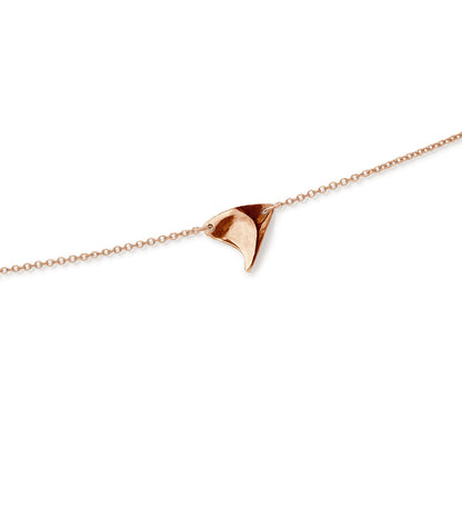 Closeup of shiny finish rose thorn in rose gold, on rose gold chain