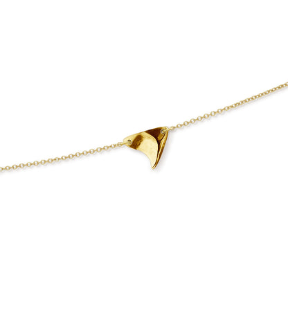 Closeup of high shine finish rose thorn in yellow gold, on yellow gold chain