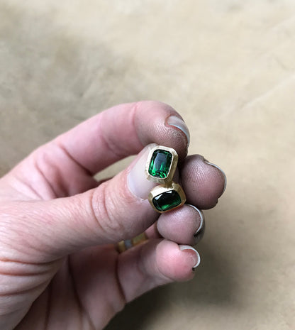 Close-up of green tourmalines in hammered 18k gold bezels