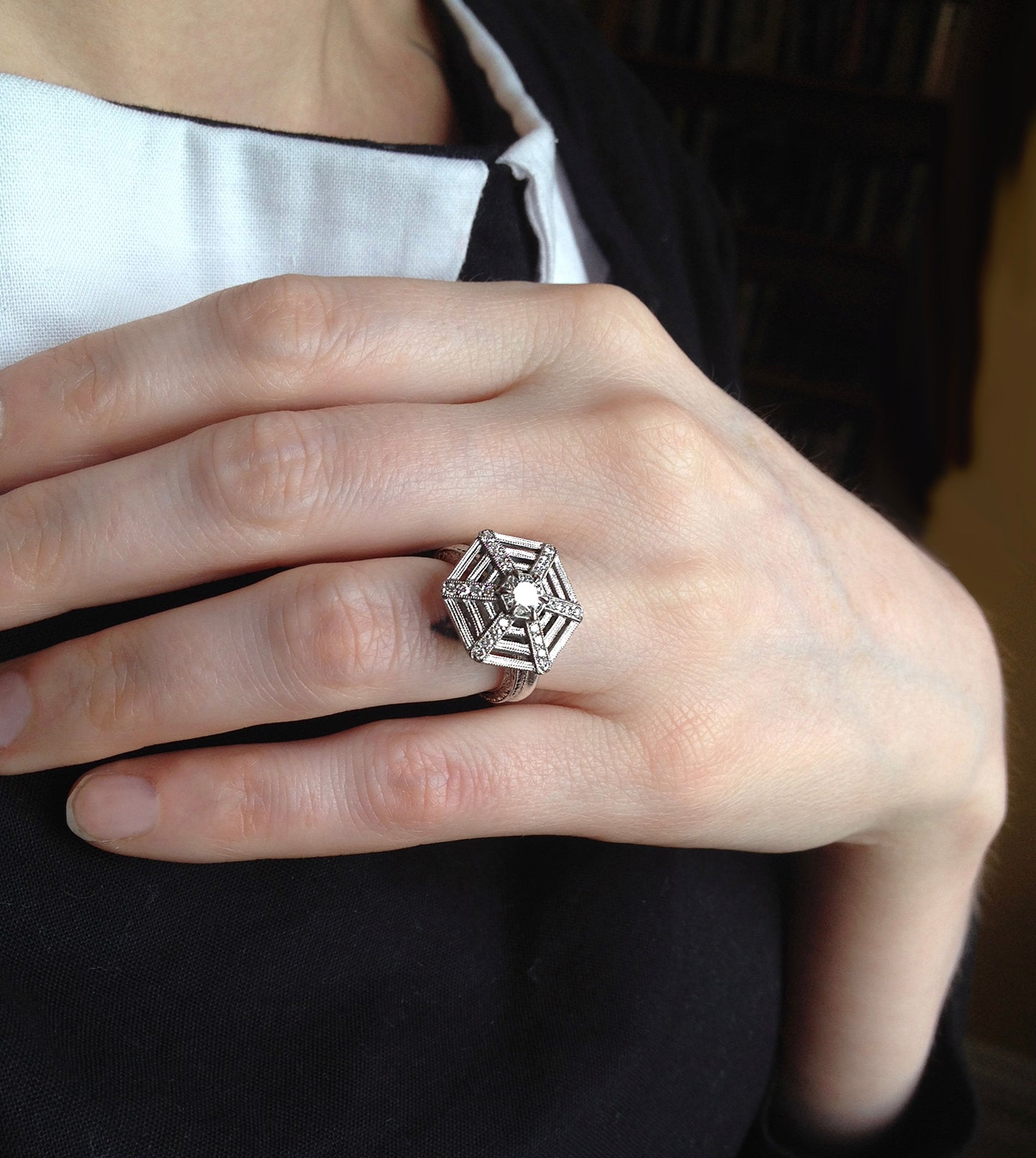 Spiderweb diamond engagement ring worn on the hand, hexagonal platinum web set with diamonds