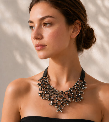 Woman wearing the blackened sterling silver Black Coral Bib Necklace