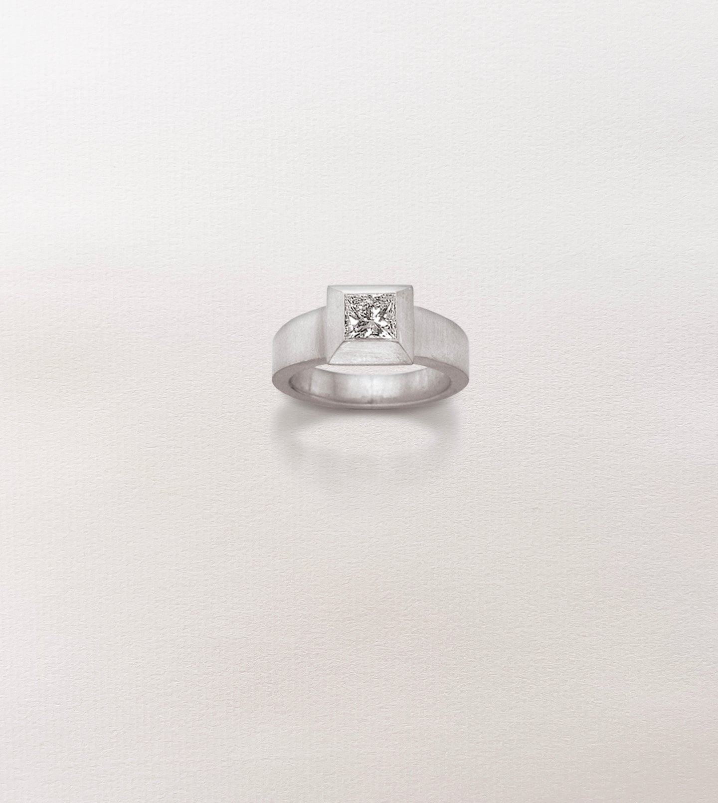 Palladium engagement ring with a princess-cut diamond in a wide beveled picture-frame setting on a wide band