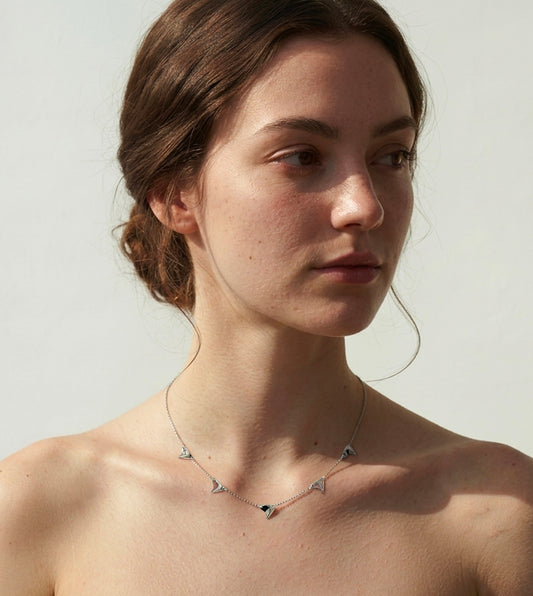 Five high shine sterling silver thorns on delicate sterling silver chain on model