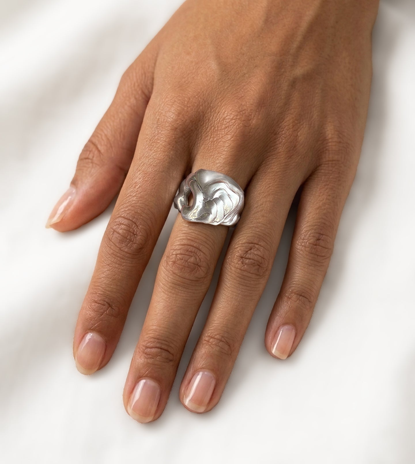 Sterling silver wave ring with a fluid, hand-shaped curve