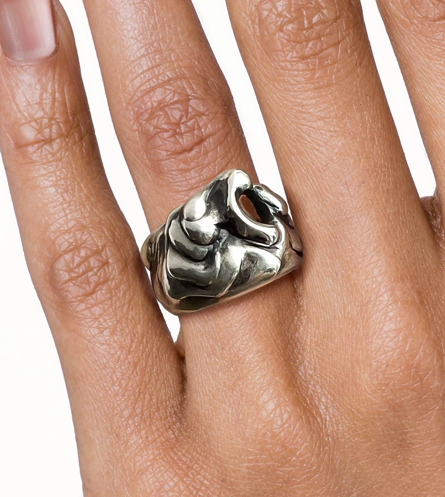 Hand wearing a polished, blackened sterling silver wave ring