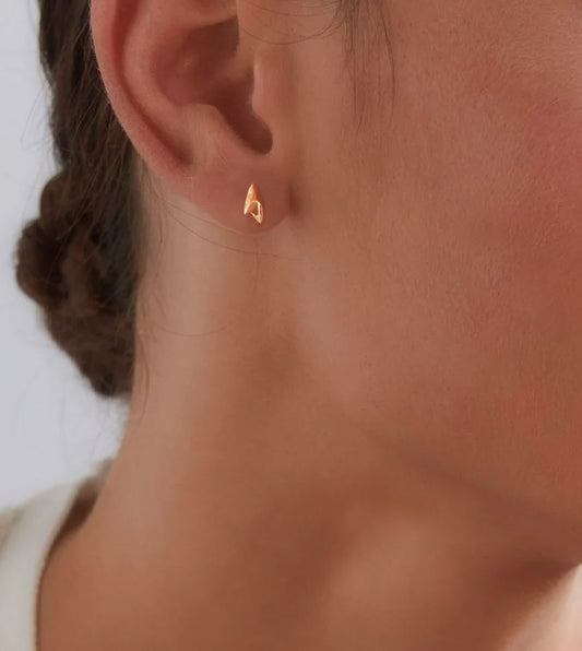 Mini high shine finish rose gold rose thorn stud earring on model