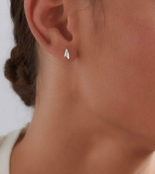 Mini high shine finish sterling silver rose thorn stud earring on model