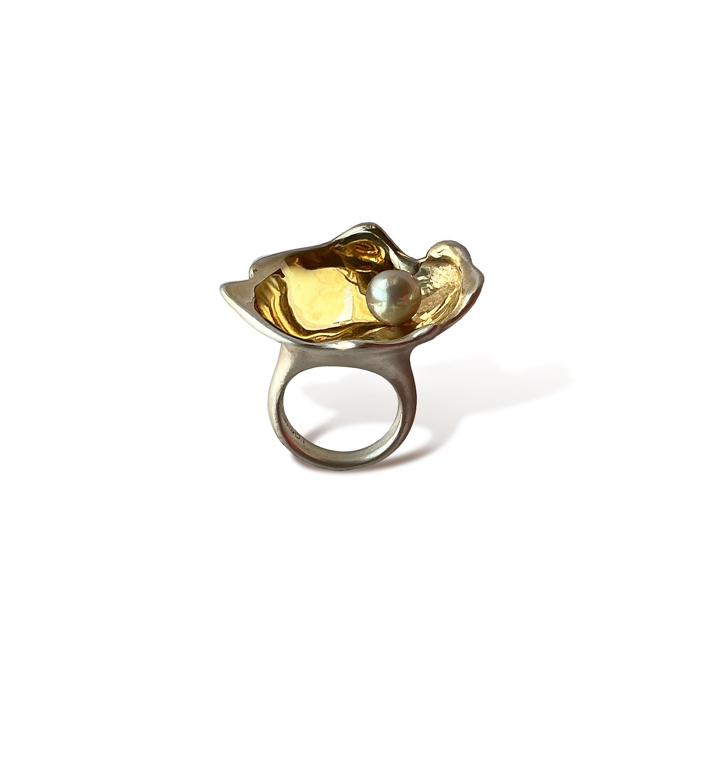 Sculptural oyster cocktail ring with a gray pearl on a neutral background