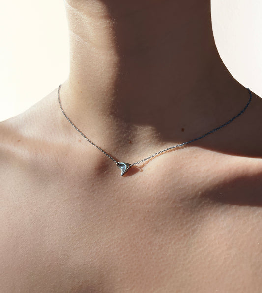 Sterling silver shiny finish single rose thorn necklace on sterling silver chain on model