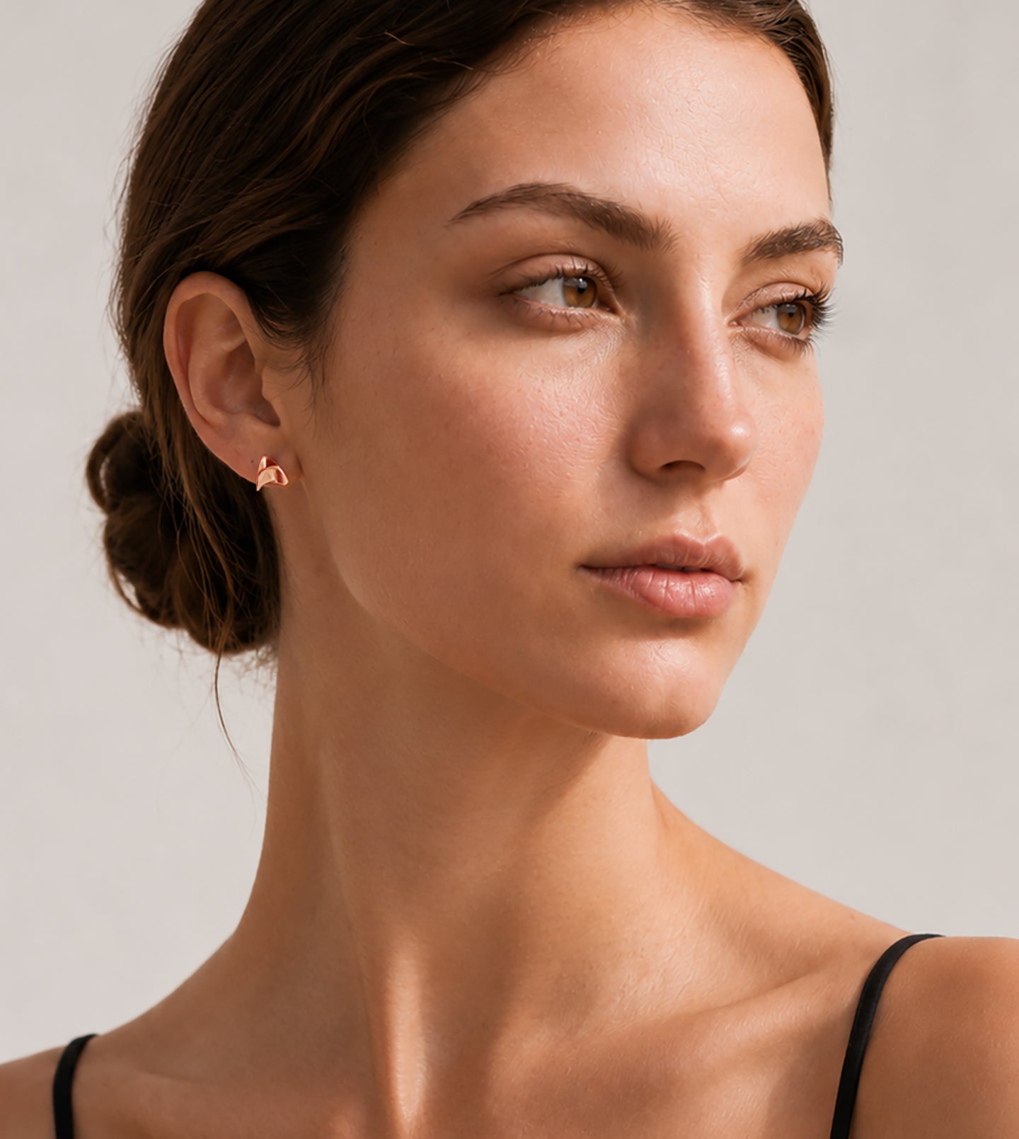 Woman wearing a 14k Rose Gold Rose Thorn Earring in shiny finish against neutral background