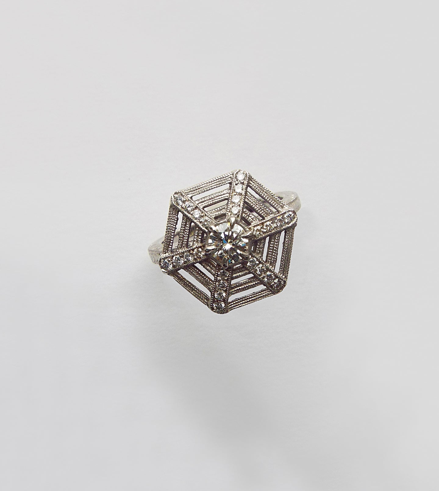 Platinum spiderweb ring, top view of the diamond-set hexagonal web